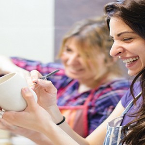 Two Women Painting on Pottery